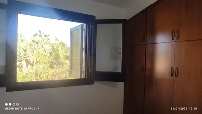 a room with a window and wooden cabinets at ViViHolidays in Castellammare del Golfo
