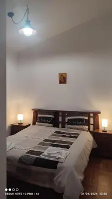a bedroom with a large bed with two lamps at ViViHolidays in Castellammare del Golfo