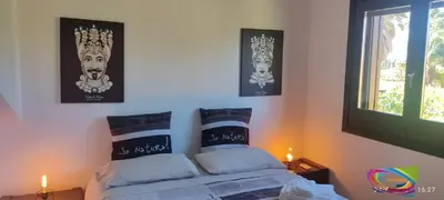 a bedroom with a bed and three pictures on the wall at ViViHolidays in Castellammare del Golfo