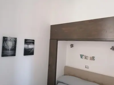 a bedroom with a bed and pictures on the wall at Stella D'Oriente in Palermo