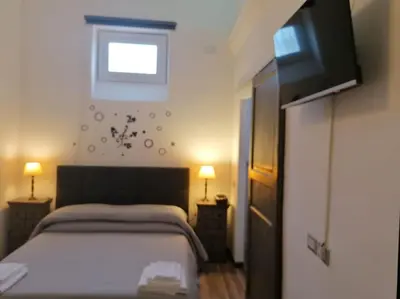 a bedroom with a bed and a flat screen tv at Stella D'Oriente in Palermo