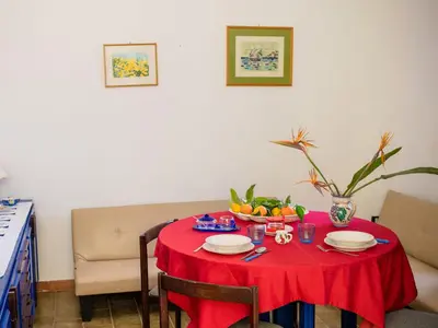 a red table with a bowl of fruit on it at Apartment Sole by Interhome in Trappeto