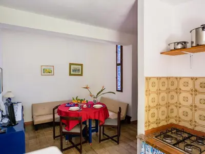 a room with a table with a red table cloth at Apartment Sole by Interhome in Trappeto