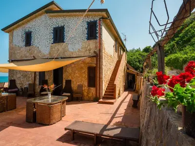 a patio of a house with a table and flowers at Apartment Luna by Interhome in Trappeto