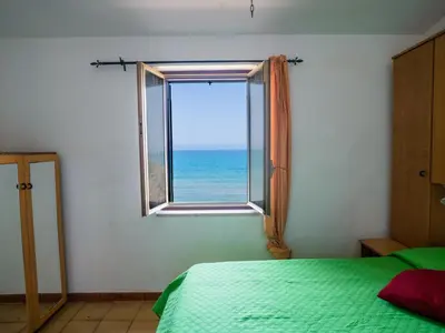 a bedroom with a window with a view of the ocean at Apartment Stelle by Interhome in Trappeto