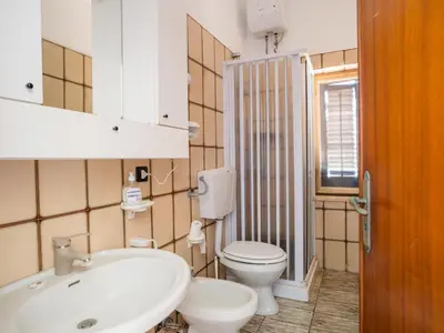 a bathroom with a white sink and a toilet at Apartment Stelle by Interhome in Trappeto
