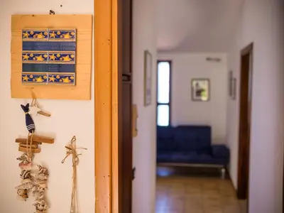 a hallway with a blue couch in a room at Apartment Stelle by Interhome in Trappeto