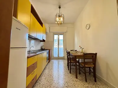 a kitchen with a table and a dining room at Ekry Apartment in Palermo