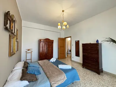 a bedroom with a large bed and a dresser at Ekry Apartment in Palermo