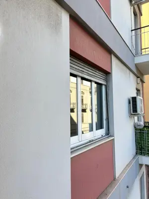 a window on the side of a building at Ekry Apartment in Palermo