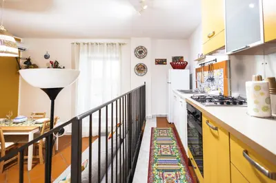 a kitchen with yellow cabinets and a counter top at Ai Bottonai Casa 23 in Palermo