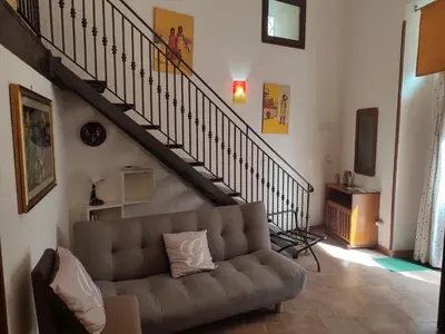 a living room with a couch and a staircase at BONELLUS in Palermo