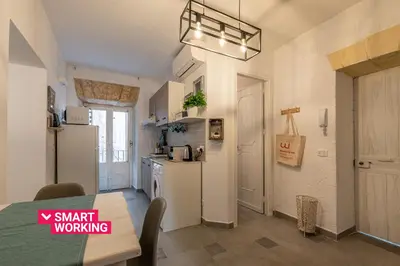 a kitchen with a refrigerator and a table in a room at Casa delle Travi by Wonderful Italy in Palermo