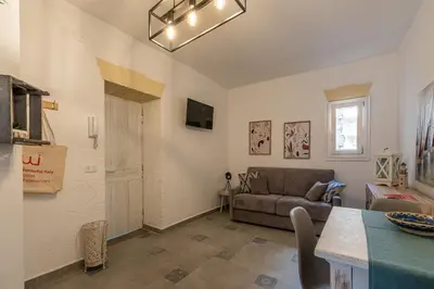 a living room with a couch and a table at Casa delle Travi by Wonderful Italy in Palermo