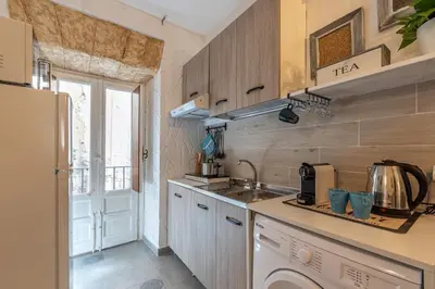 a small kitchen with a sink and a window at Casa delle Travi by Wonderful Italy in Palermo