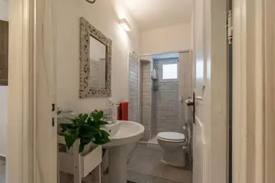 a bathroom with a sink and a toilet and a mirror at Casa delle Travi by Wonderful Italy in Palermo