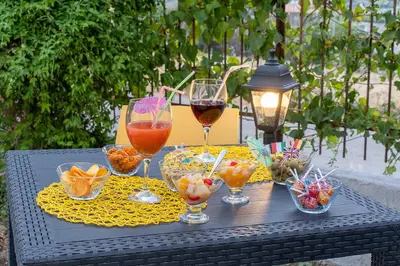a black table with glasses of wine and snacks at Casa Lachesi in Caccamo