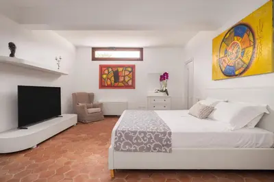a bedroom with a bed and a flat screen tv at Villa lady olimpia in Palermo
