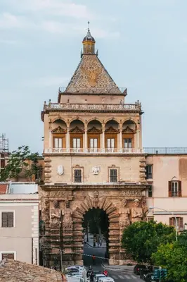an old building with a tower on top of it at Porta dei Mori Apartment in Palermo