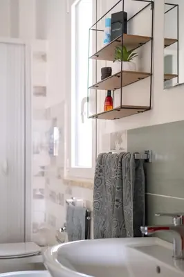 a bathroom with a sink and a mirror at Porta dei Mori Apartment in Palermo