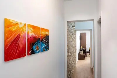 a hallway with four paintings hanging on a wall at Ayres Del Mar in San Vito lo Capo