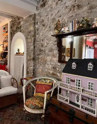 a room with a chair and a doll house at A Casa da Paola in Caccamo