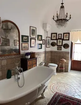 a large bathroom with a tub and a toilet at A Casa da Paola in Caccamo