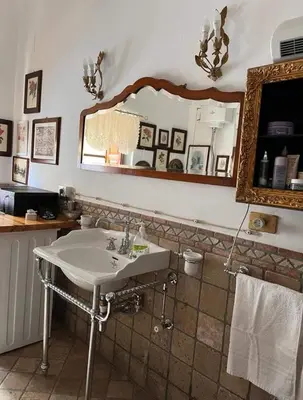 a bathroom with a sink and a mirror at A Casa da Paola in Caccamo
