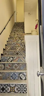 a hallway with a staircase with tiled floors at Vintage Room Palermo in Palermo
