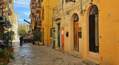 a person walking down a street in an alley at Vintage Room Palermo in Palermo