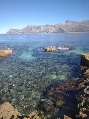 a view of a body of water with rocks at Modus B&B in San Vito lo Capo