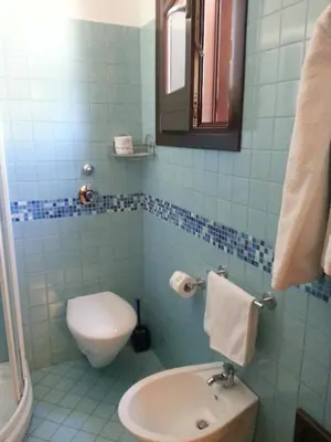 a bathroom with a toilet and a sink at Modus B&B in San Vito lo Capo
