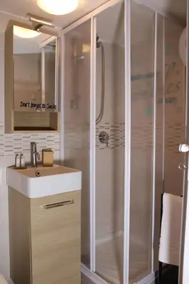 a bathroom with a shower and a sink at A' Nica room in Palermo