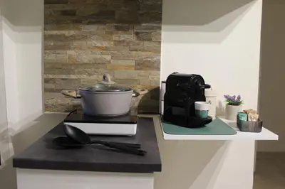 a kitchen counter with a pot and a coffee maker at A' Nica room in Palermo