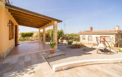 a patio of a house with a wooden deck at Gorgeous Home In Altavilla Milicia in Altavilla Milicia