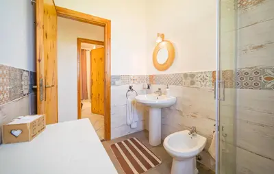 a bathroom with a sink and a toilet at Gorgeous Home In Altavilla Milicia in Altavilla Milicia
