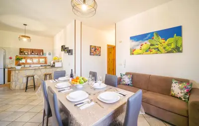 a living room with a table and a couch at Gorgeous Home In Altavilla Milicia in Altavilla Milicia
