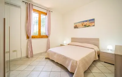 a white bedroom with a bed and a window at Gorgeous Home In Altavilla Milicia in Altavilla Milicia
