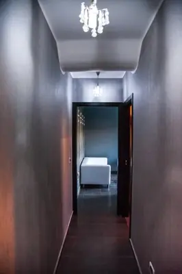a hallway with a room with a white bed in it at Villa Salvo in Balestrate
