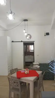 a dining room with a table with a red blanket on it at Casa Chiaretta in Palermo