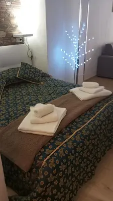 a bed with towels sitting on top of it at Casa Chiaretta in Palermo