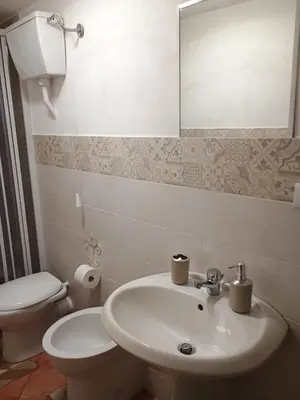 a bathroom with a sink and a toilet and a mirror at casa centro storico O Capu in Palermo