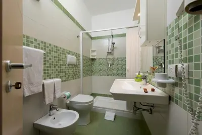 a small bathroom with a sink and a toilet at B&B Armonie in San Vito lo Capo
