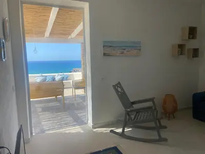 a room with a chair and a view of the ocean at Addauro in Alcamo