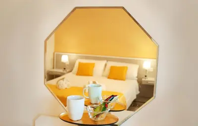 a mirror reflecting a bed in a hotel room at *1*7*4* Via Roma in Palermo
