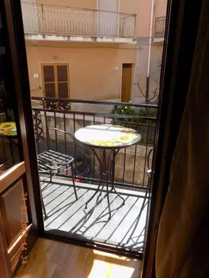 a balcony with a table and chairs on a balcony at B&B Porta delle Madonie in Campofelice di Roccella