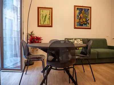 a dining room with a glass table and chairs at La Premiere Suite - Teatro Massimo Palermo in Palermo
