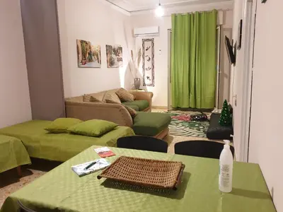 a living room with two green tables and a couch at Dolce casa centro storico di Palermo new 2023 in Palermo