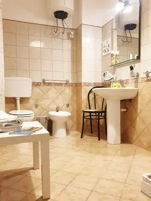 a bathroom with a toilet and a sink and a mirror at Dolce casa centro storico di Palermo new 2023 in Palermo