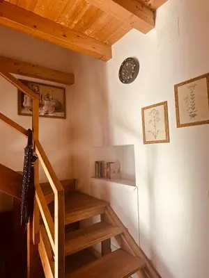 a staircase in a room with a wooden ceiling at Casa nonno Enrico in via Oreto in Palermo